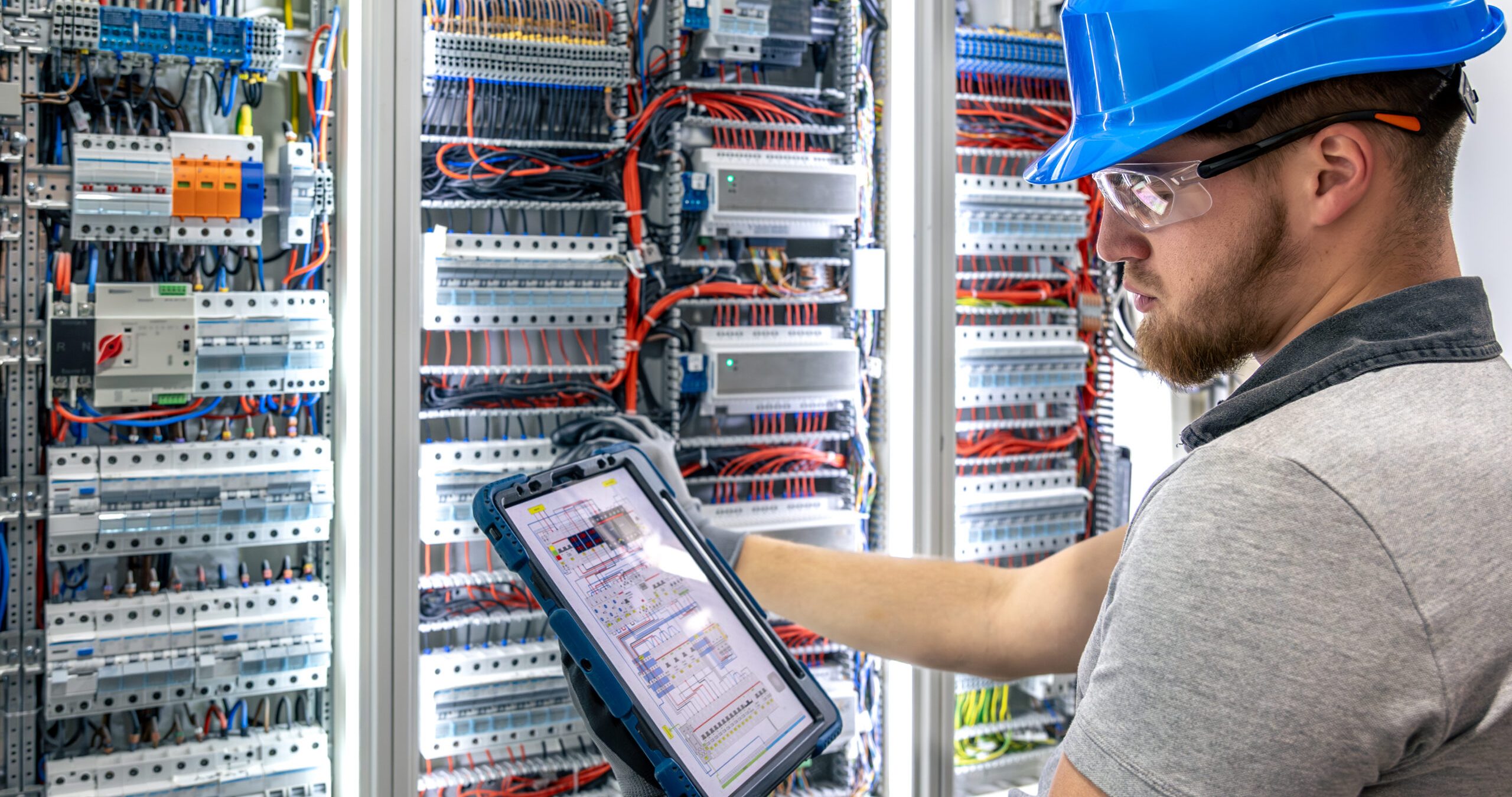 electrician with tablet. circuit inspection. pre installation check.